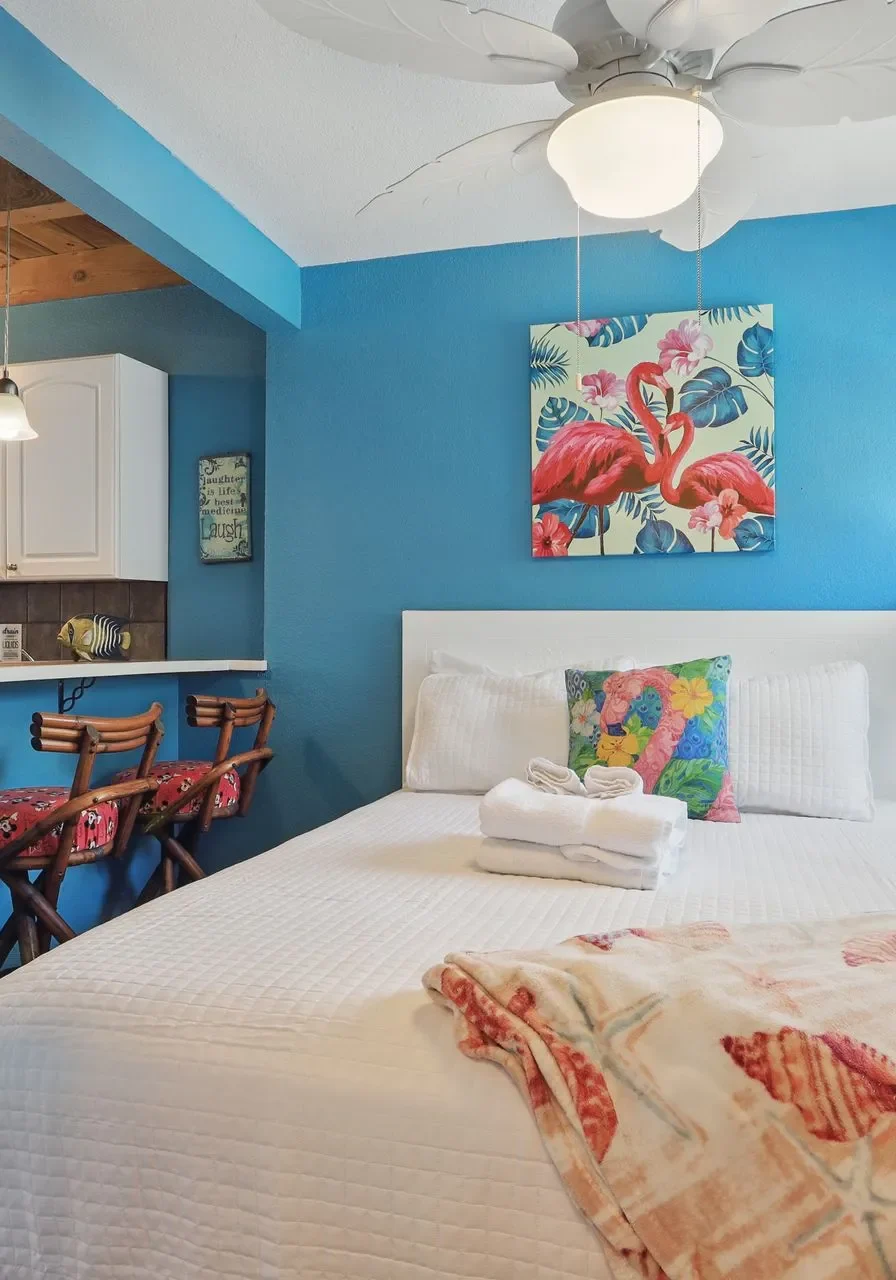 Cozy bedroom with blue walls and modern decor.