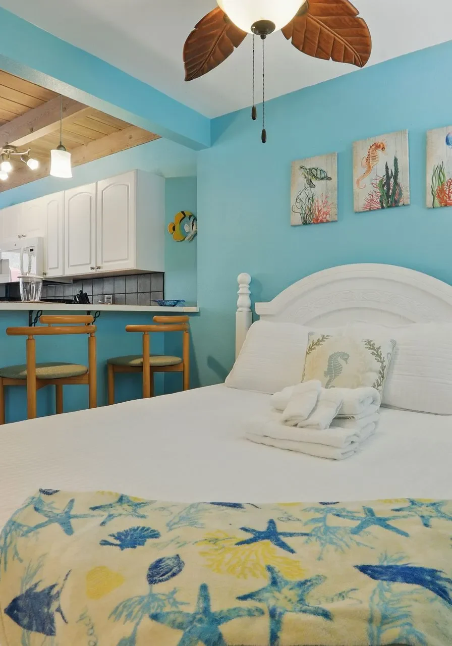 Cozy bedroom with a single bed and beach-themed decor.