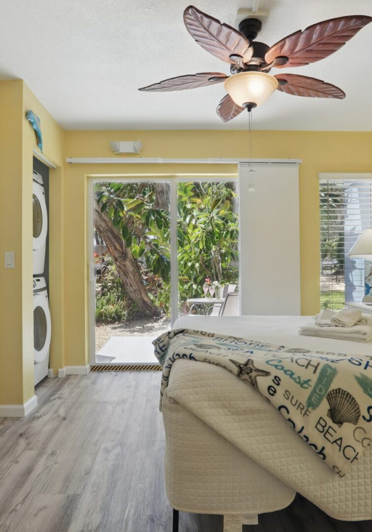 Cozy bedroom with yellow walls and garden view.